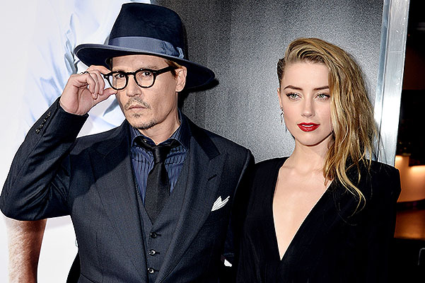 LOS ANGELES, CA - FEBRUARY 12:  Actor Johnny Depp (L) and his fiancee actress Amber Heard arrive at the premiere of Relativity Media's "3 Days To Kill" at the Arclight Theatre on February 12, 2014 in Los Angeles, California.  (Photo by Kevin Winter/Getty Images)